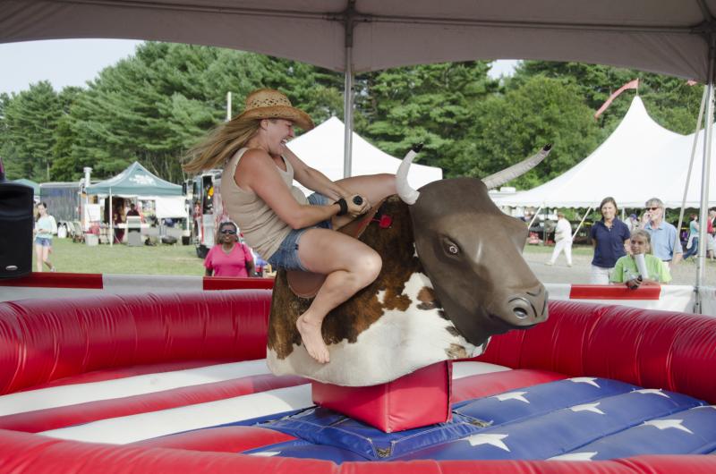 Yee haw! Jessica Zell of Rochester stayed on the mechanical bull for 25 seconds. Asked why she gave it a try, Zell pointed to her family and said, "They did it. I figured I had to give it a shot." BY GEORGIA SPARLING
